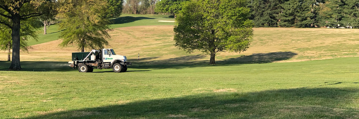 speader truck on a golf course